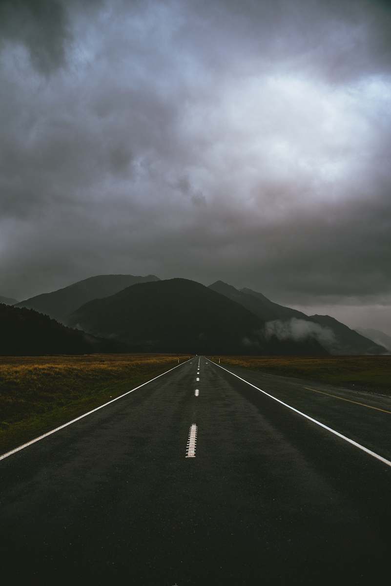 grey gray road under cloudy sky milford sound highway